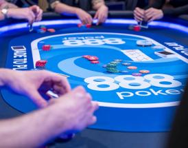 Players around an 888poker table during a live poker game