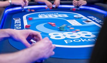 Players around an 888poker table during a live poker game